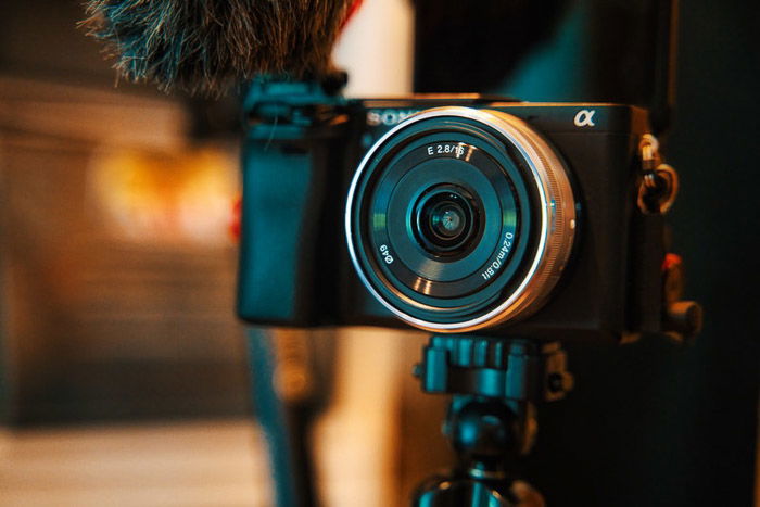 A Sony compact camera with a Pancake lens on a tripod