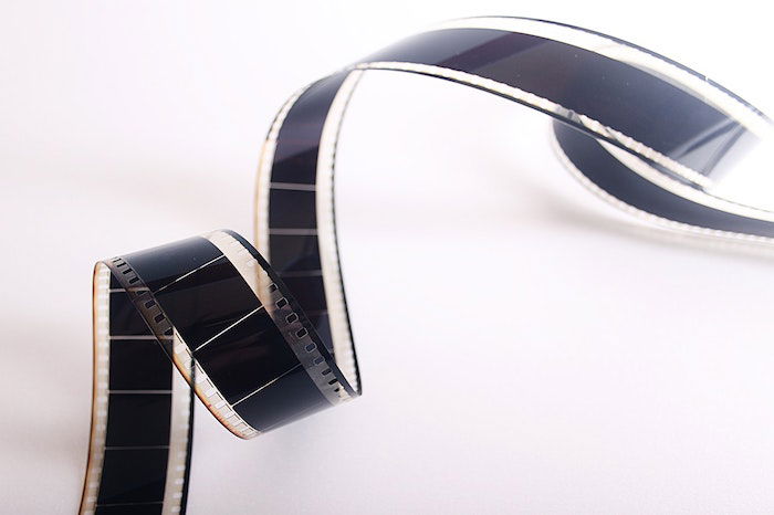 A strip of black film on a white surface.