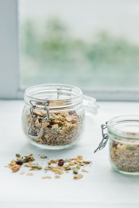 Photo of a jar of oats in front of a window