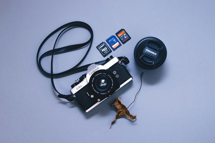 Photo of a camera and three different types of memory cards