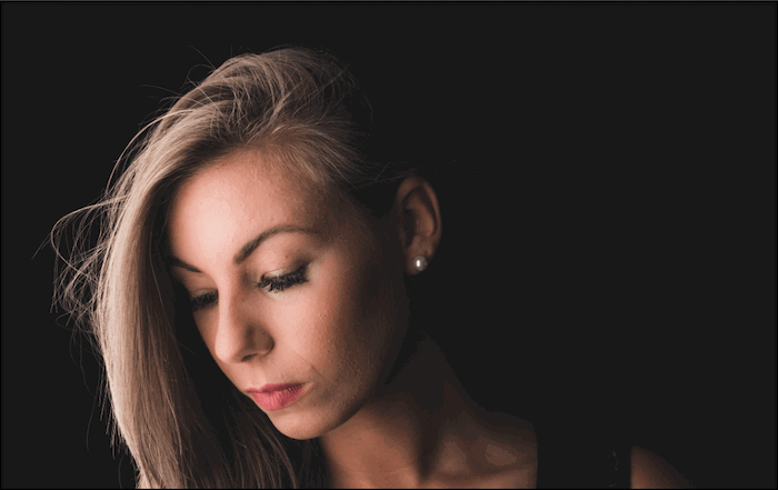 Portrait photo of a woman with dark background