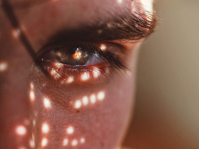 A close-up photo of an eye with patterned light