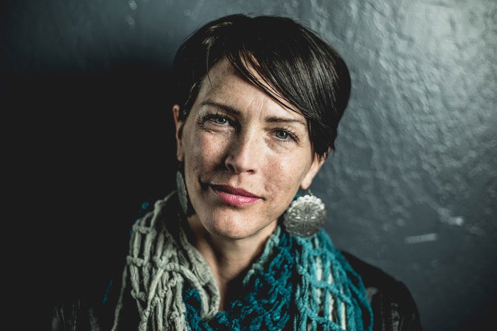 Portrait of a woman against a grey background