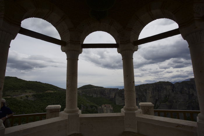 A landscape scene shot through pillars of a building. The sky is correctly exposed, making the pillars too dark. 