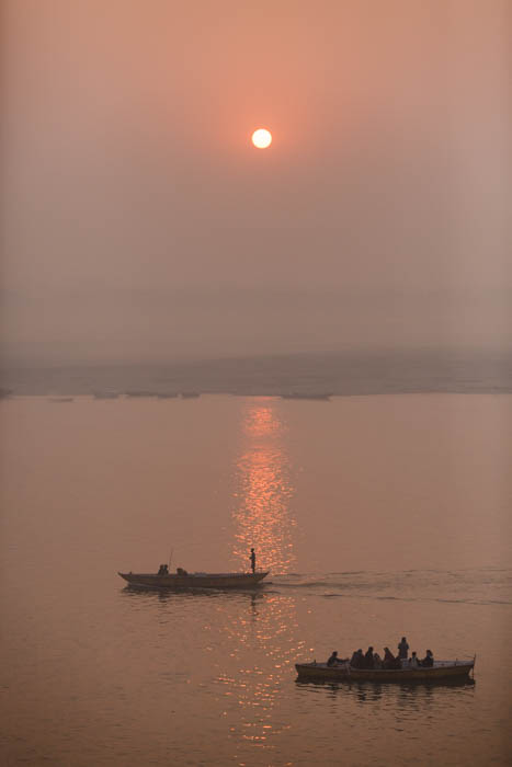 Photo of ships on a river at sunset