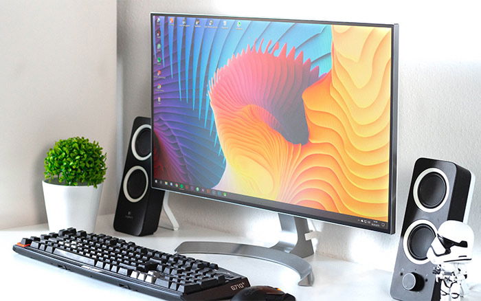 A colorful photo editing monitor on a desk