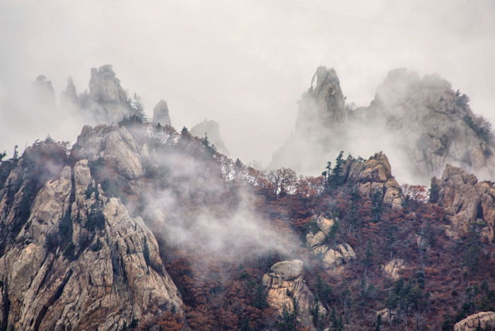 mist covered mountains shot with full zoom on a 300mm lens with a full frame DSLR.