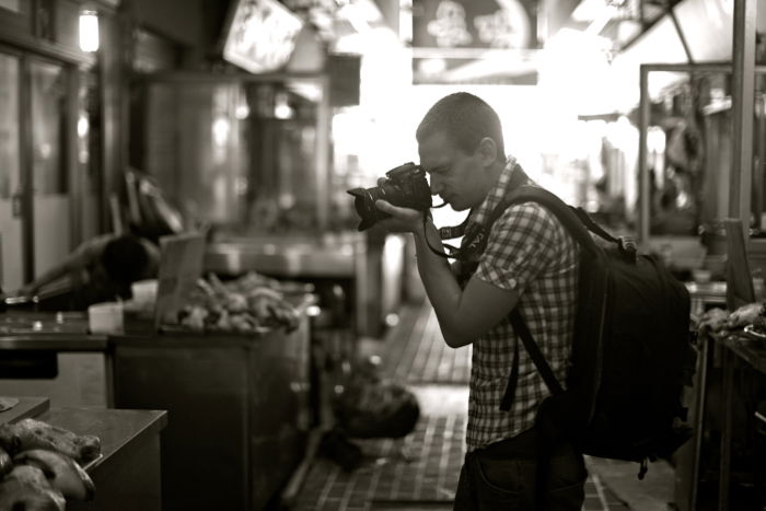 A photographer with a camera and backpack