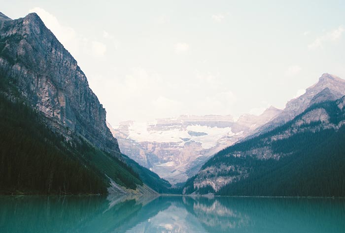 A landscape photo of mountains surrounding a lake 