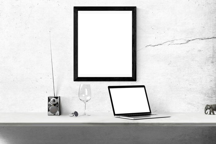 Black and white photo of a mirror and a laptop