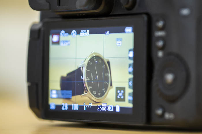 The digital display of a camera showing a watch on the screen 