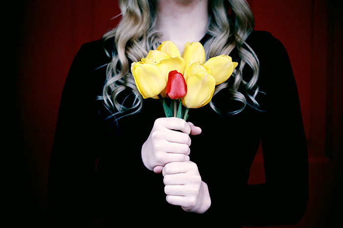 a close up of a person holding flowers at a funeral 