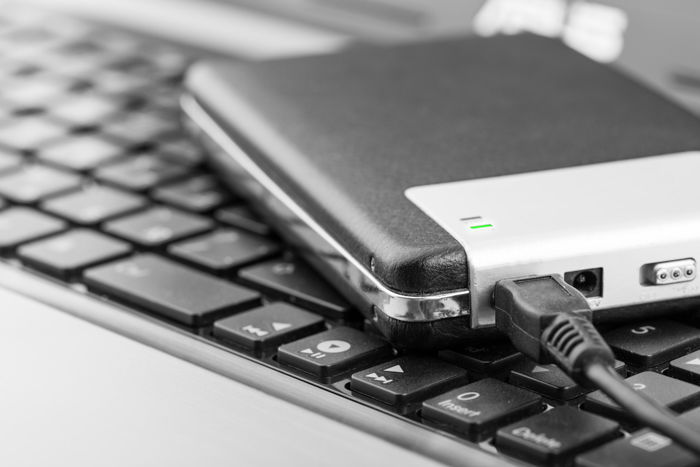 Photo of an external hard drive sitting on top of a laptop