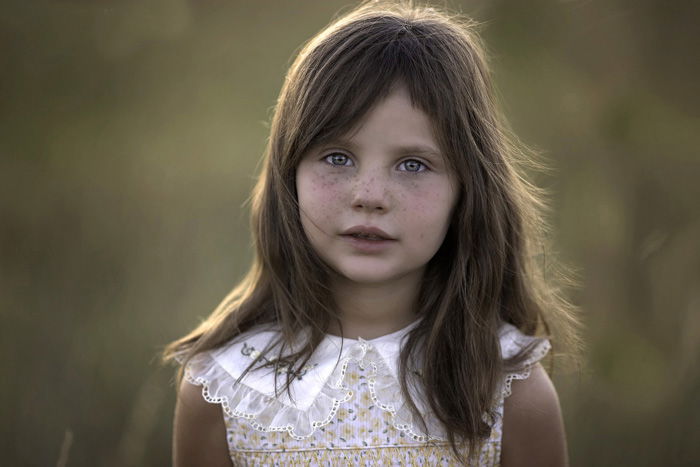 Portrait photo of a girl with freckles