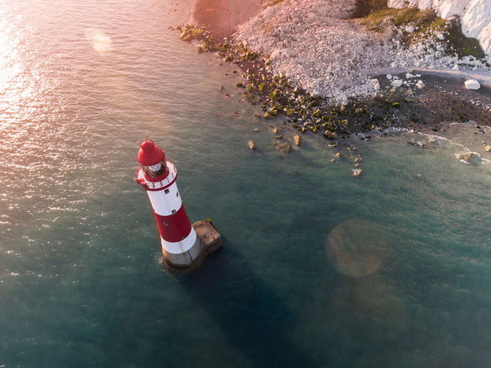 photo of a lighthouse with lens flare