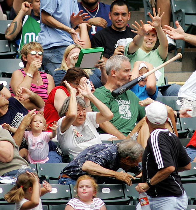 Photo of a baseball bat hitting the face of a man