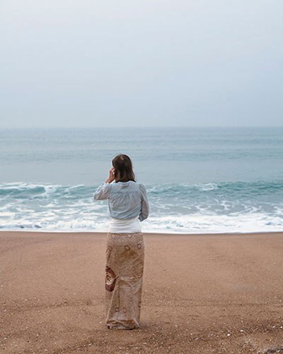 Photo of a woman standing on a beach