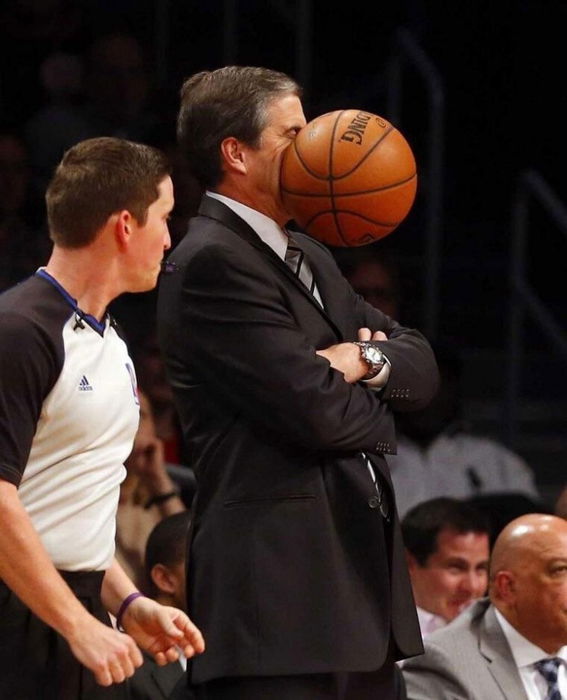 Perfectly timed photo of a basketball hitting a man's face