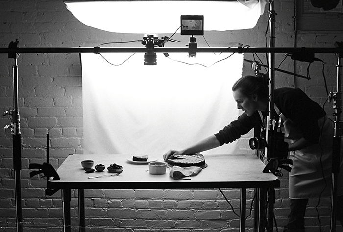 Photo of a photographer setting the composition for food photography