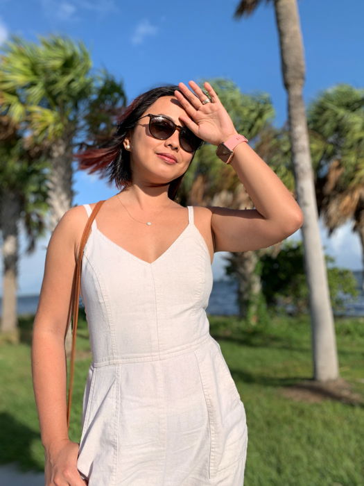 Portrait photo of a woman with palm trees in the background