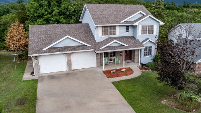 drone photo of a house with blue walls