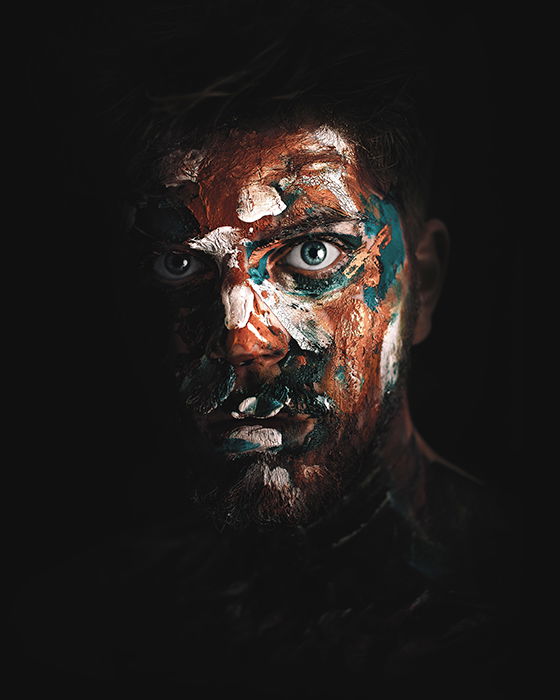 Surreal portrait photo of a man with painted face