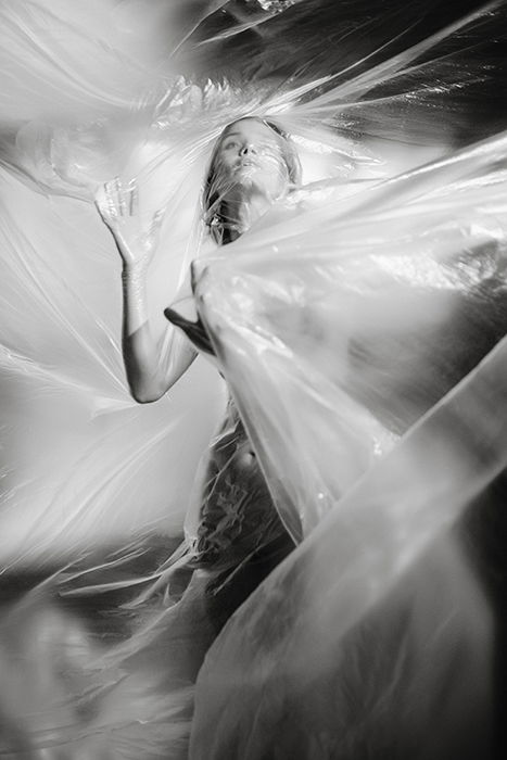 Surreal photo of a woman with a textured layer of scaffolding draped over her