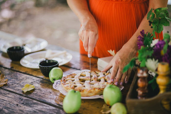 Photo of a woman cutting up a pie