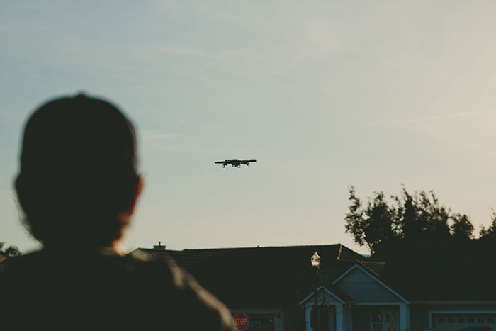 Photo of a drone flying above a house