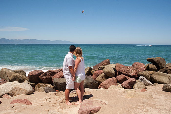 Romantic portrait of a couple holding hands on the beach