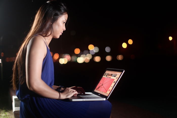 a lady using google drive from a computer to transfer photos 