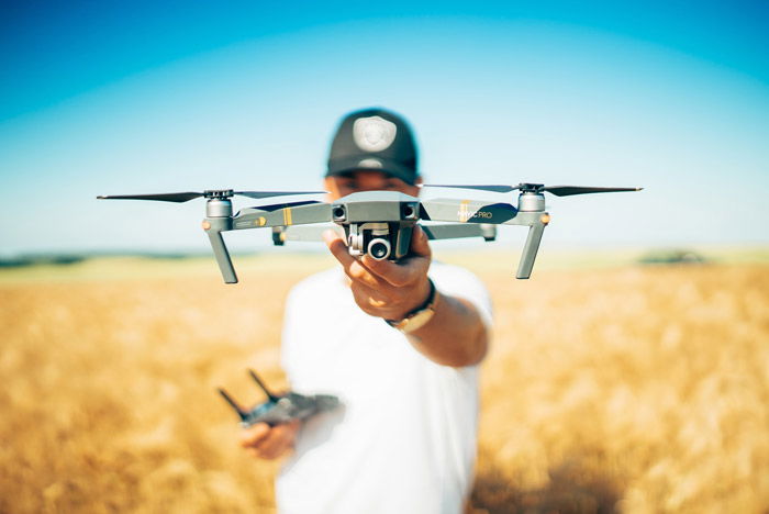 Photo of a man holding a drone