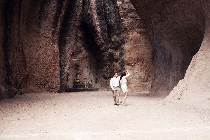 a romantic portrait of a couple dancing in a cave