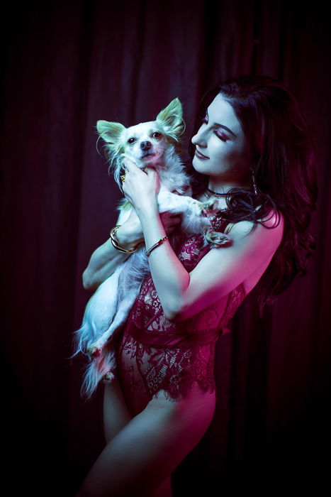 Boudoir photo of a woman and a dog