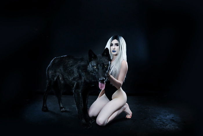 Boudoir photo of a woman with a wolf