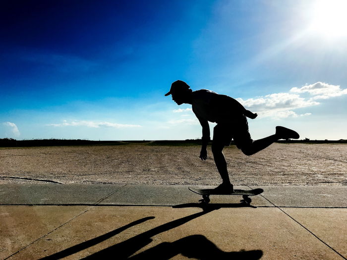 Silhouette of a man skateboarding