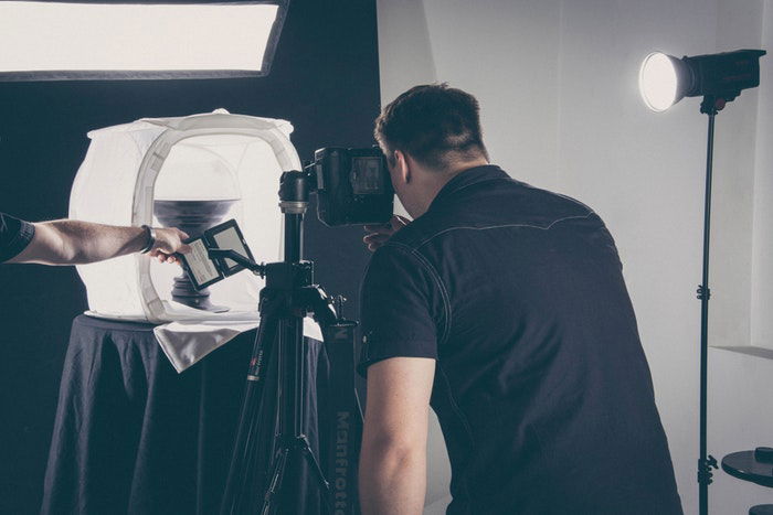 Photo of a man taking a product photo