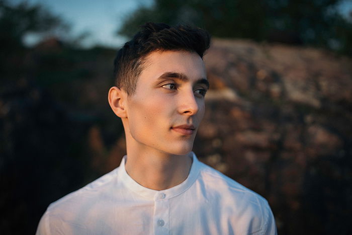 portrait of a male model posed outdoors