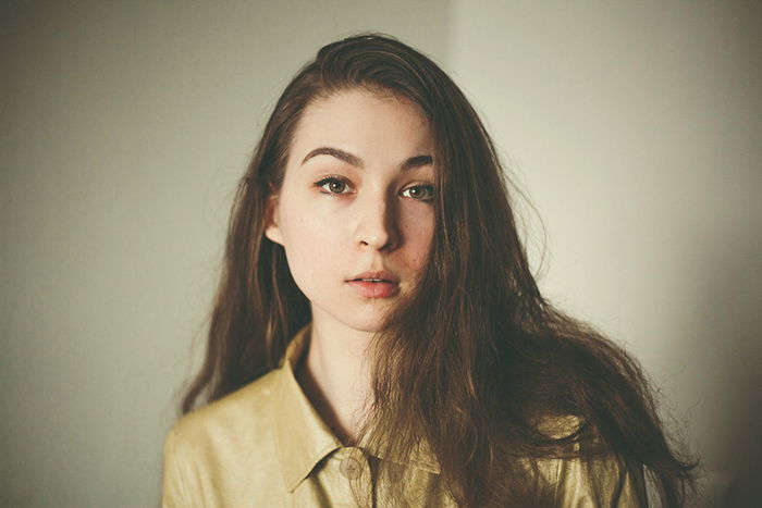 a professional headshot photo of a young woman