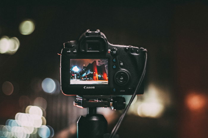 A canon camera on a tripod 