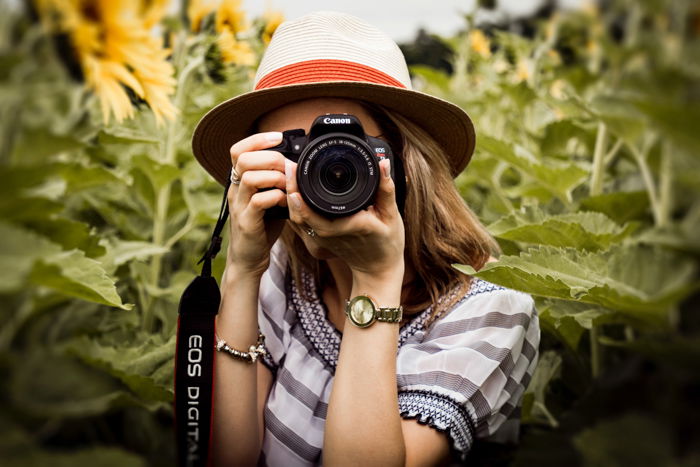 A girl taking a photo with a Canon camera 