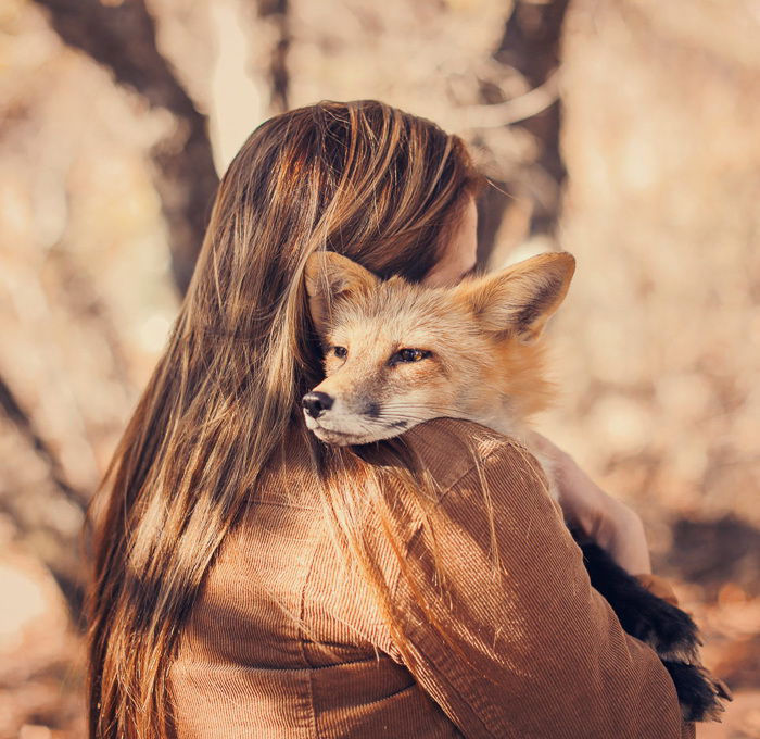 Photo of a girl holding a fox