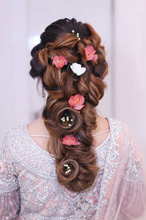 A wedding hair style with flowers and pearls 