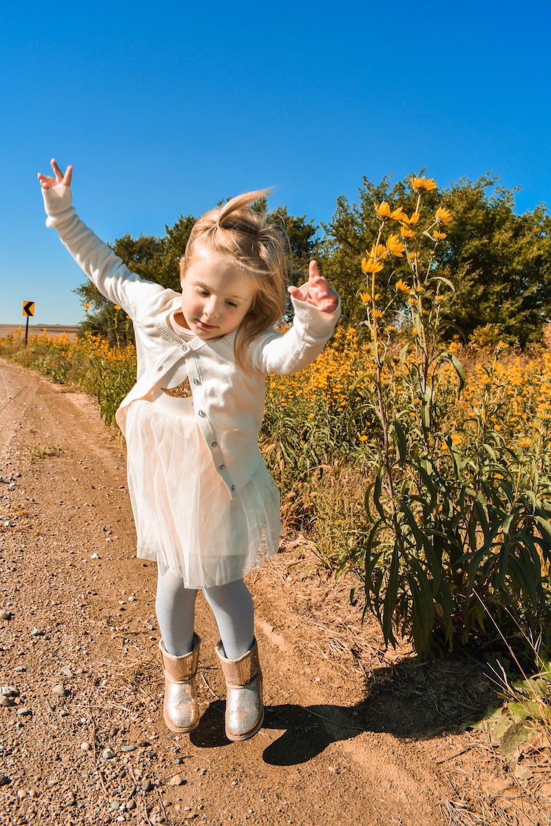 A toddler dancing for a kids photo pose