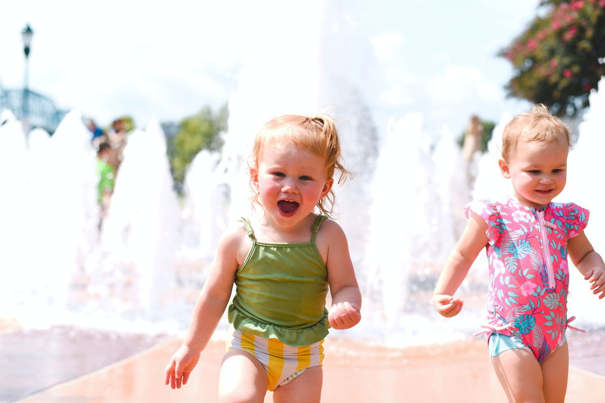 Two toddlers running for a kids photo pose