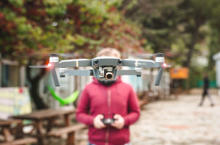 photo of a person flying a drone