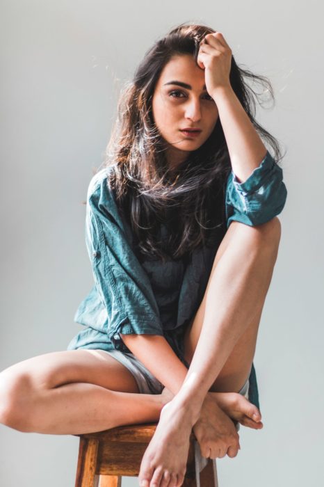 Portrait photo of a woman sitting on a chair indoors