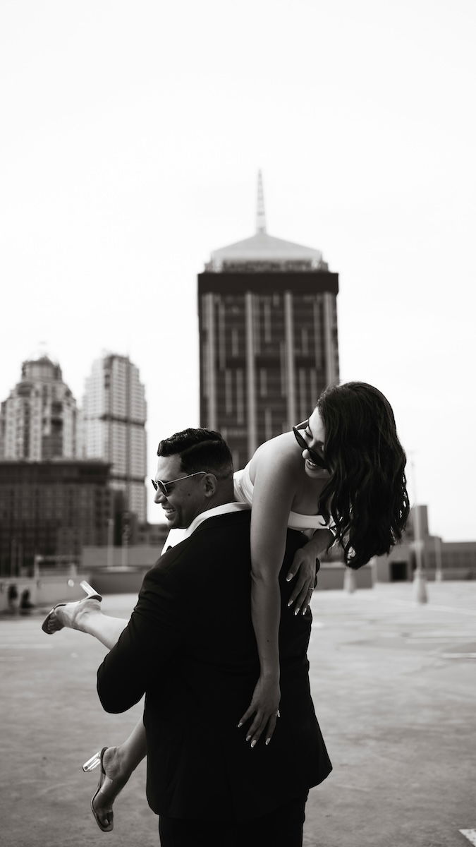 A man with a woman over his shoulder for couple poses