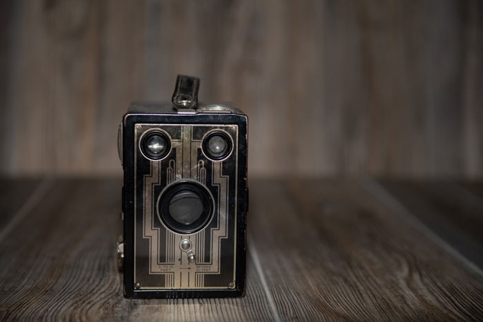 A vintage camera product photography shot with a bare flash