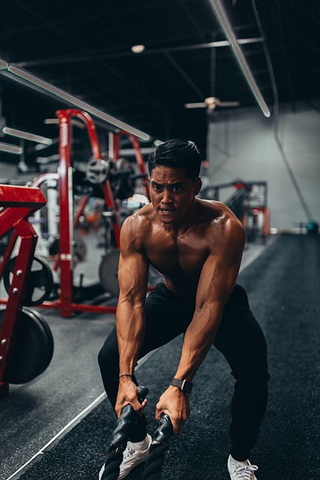 A man lifting weights in the gym for a fitness photoshoot 